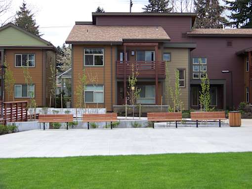 A row of houses with a green lawn in front.at Bridge Meadows North Portland 55+, Portland, OR 97203