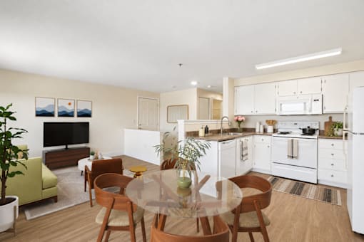 A modern kitchen with a dining table and chairs.