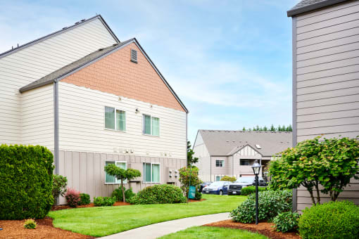 Building exteriors and lush landscaping at Devonwood and First Place Apartments, Battle Ground
