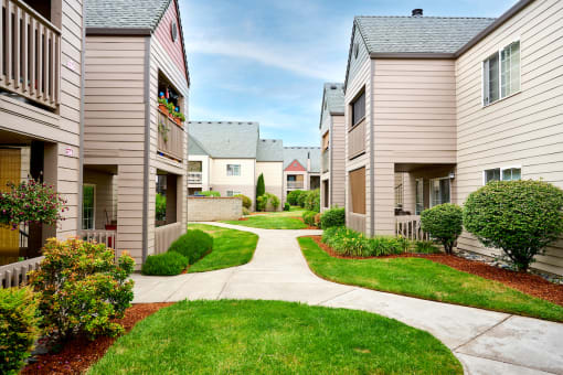 Building exteriors and lush landscaping at Devonwood and First Place Apartments, Battle Ground, WA 98604