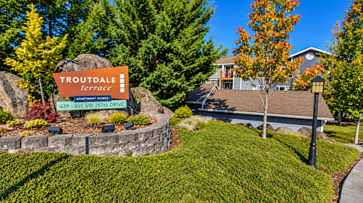 A sign for Troutdale Terrace stands in front of a house.