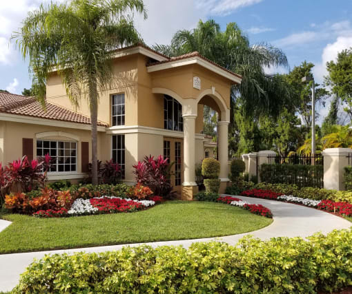 a home with a round driveway and palm trees at Hibiscus Pointe, Miami Florida 