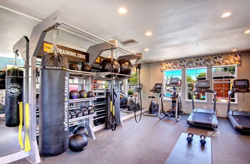 Dupont Apartments - Clock Tower Village - Resident Fitness Center With Treadmills, an Elliptical, a Punching Bag, and Handweights
