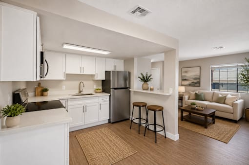 Open concept kitchen and living room with breakfast bar at Dash Apartments, Las Vegas
