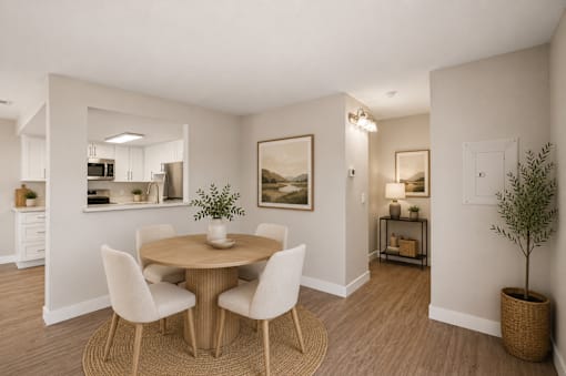 Dining area with round table and upholstered chairs at Dash Apartments, Nevada