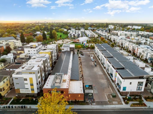 an aerial view of a suburb of a city with houses and cars