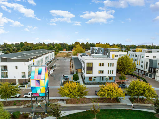 an aerial view of an apartment complex with a colorful building in the middle