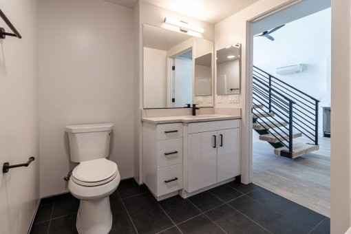 a bathroom with a toilet and a sink and a mirror at Luella, California