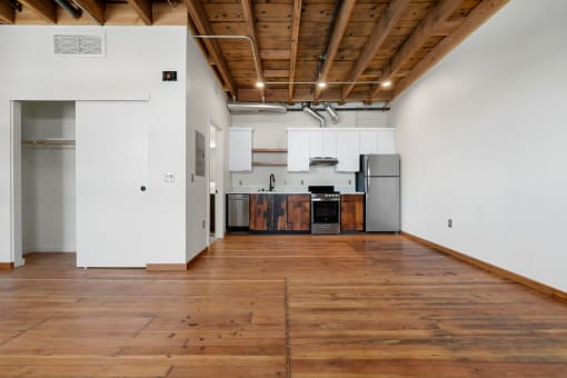 a large empty room with white walls and wood floors