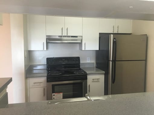 kitchen cabinets and stainless steel appliances at The Edge at Town Center Apartments, Jacksonville