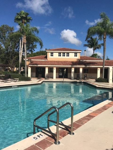 Pool with lounge chairs Golden Lakes Apartments Miami Florida