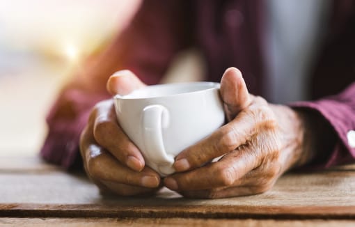Enjoying a hot beverage at DOVER WOODS SENIOR APARTMENTS, Fairfield California