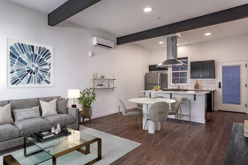 a living room and kitchen area with white walls and hardwood floors at THE ANGELINO, Sacramento, CA