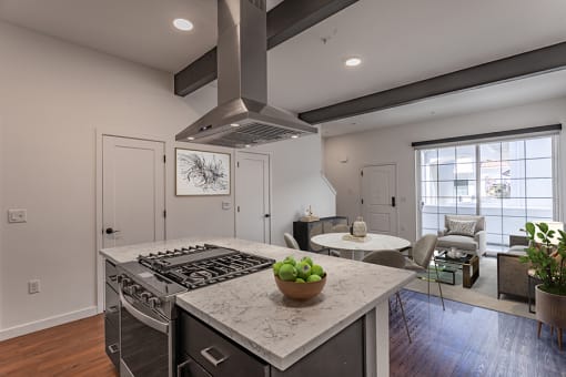 a kitchen with a stove and a table with chairs at THE ANGELINO, California, 95819