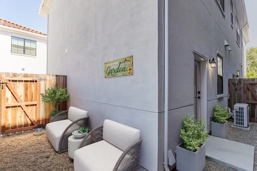a patio with two chairs and a table at THE ANGELINO, Sacramento, CA 95819