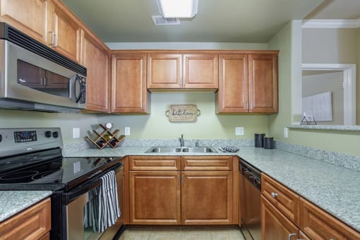 Elk Grove, CA Apartments for Rent- Castellino at Laguna West- Stainless-Steel Appliances with Granite-Style Countertops and Wooden Cabinets