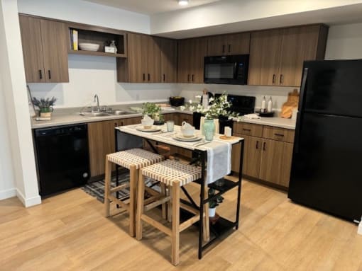 a kitchen with a bar with three stools at FARM BY VINTAGE, Washington