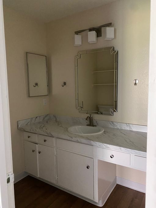 A white bathroom with a walk in shower and a toilet.at Via Casitas, Greenbrae, CA 94904