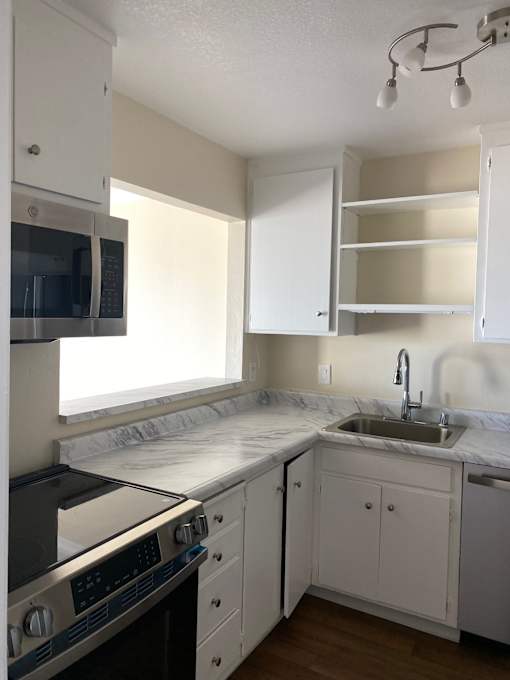 A small kitchen with a stove and a sink.at Via Casitas, Greenbrae California