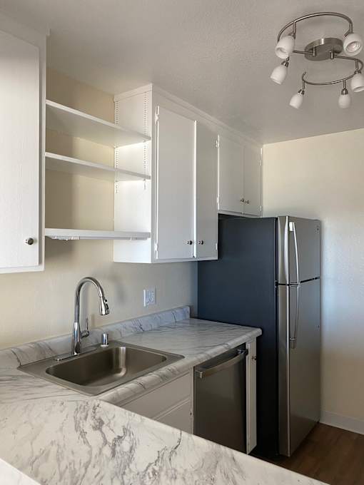 A kitchen with a sink and a dishwasher.at Via Casitas, Greenbrae, CA