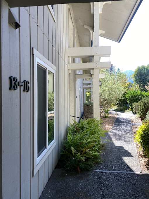 A white deck with a glass window and a white railing.at Via Casitas, Greenbrae California