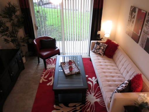 Monterey Pointe Apartments apartment home living area with balcony at Monterey Pointe, Homestead, FL