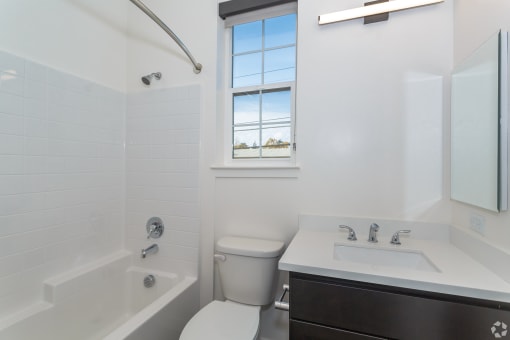 a bathroom with a tub and a toilet at THE ANGELINO, Sacramento, CA