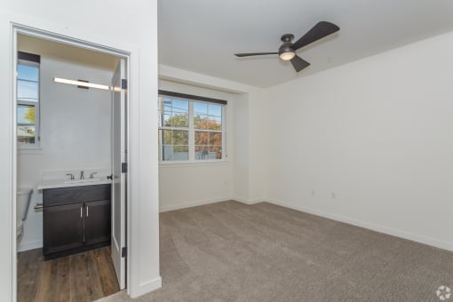a bedroom with a large window and a ceiling fan at THE ANGELINO, Sacramento California