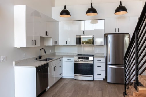 a kitchen with white cabinets and stainless steel appliances at Luella, Sacramento, CA, 95811