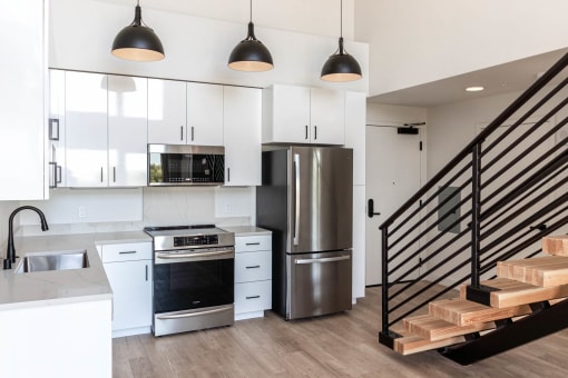 a kitchen with white cabinets and a stainless steel refrigerator at Luella, Sacramento, California