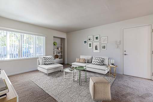 A living room with a white couch, a green coffee table, and a rug at Lake Washington Apartments, Seattle, WA