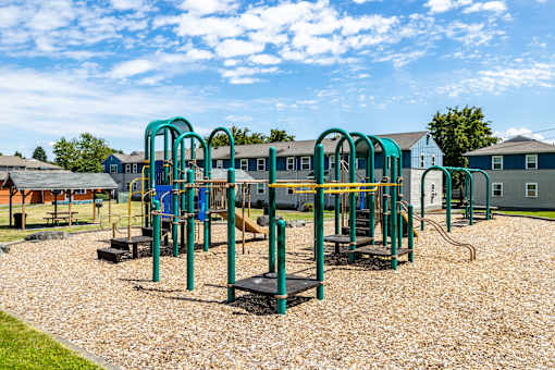 A playground with a slide, swings, and a seesaw.at Lake Washington Apartments, Seattle, 98118