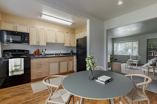 A modern kitchen with a dining table set for two at Lake Washington Apartments, Seattle