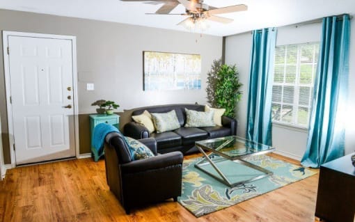 Living room with window and wood floors at ARBORS OF KILLEEN, KILLEEN, TX