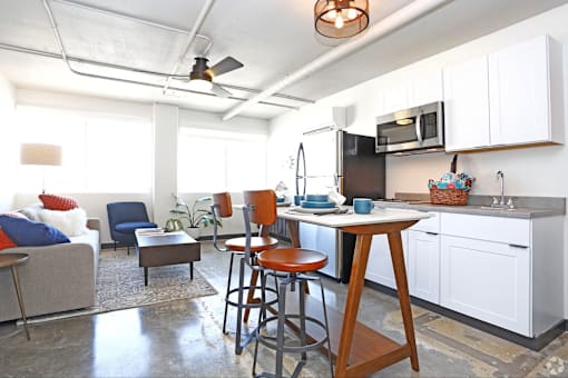 A kitchen with a table and chairs in the middle of the room at LOFT 205 Apartments, Reno
