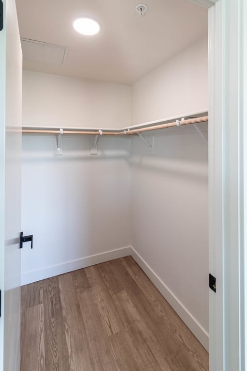 a room with a wood floor and a white wall with ceiling at Luella, Sacramento, CA, 95811