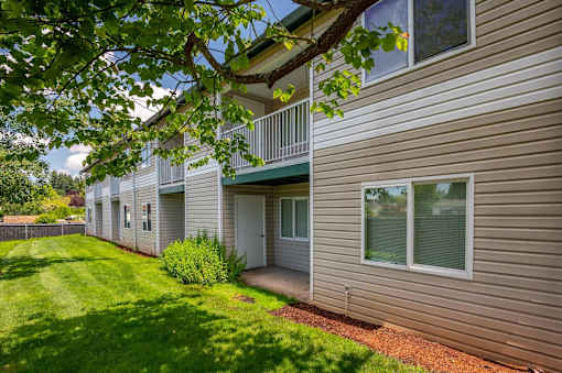 A building with a green lawn in front.at Vancouver Mall Apartments, Vancouver, WA 98662 ? 