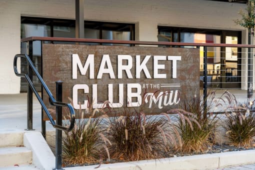 the sign for market club in front of a building