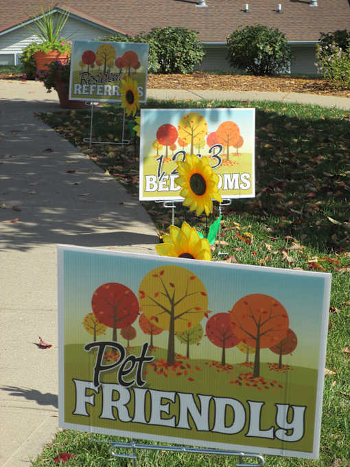 A sign that says Pet Friendly is in front of a house.