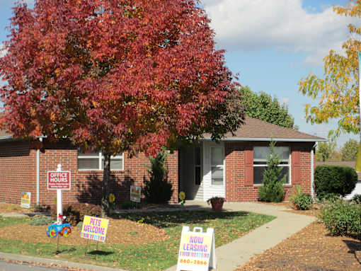 A house with a sign that says "NOW LEASING" in front of it.