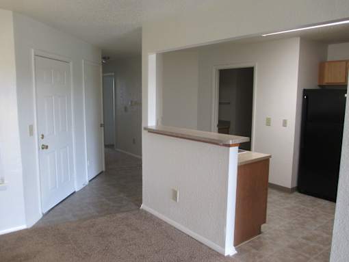 A white room with a brown counter.