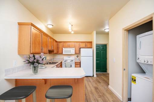 A kitchen with wooden cabinets and a white counter top. at Fairview Village Homes, Fairview, OR