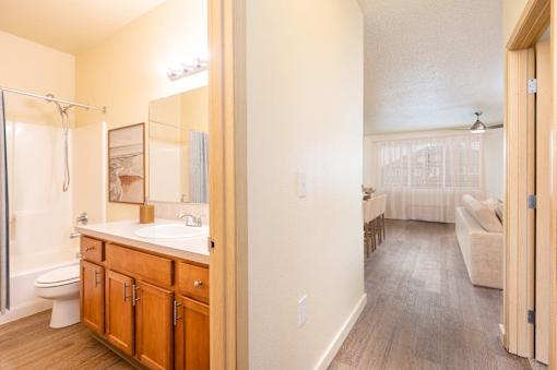 A bathroom with a walk-in shower and a vanity with a mirror. at Fairview Village Homes, Fairview, 97024