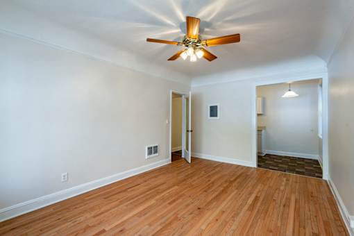 A room with a ceiling fan and wooden flooring.at Palladian Apartments, Oregon ? 