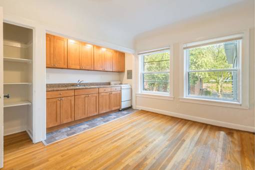 A kitchen with wooden floors and cabinets.at Palladian Apartments, Oregon, 97201?
