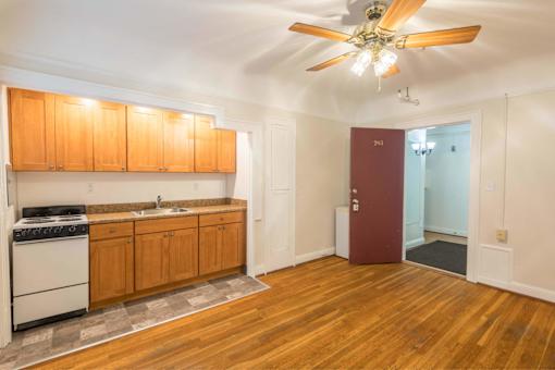A kitchen with wooden floors and a ceiling fan.at Palladian Apartments, Portland, 97201 ? 