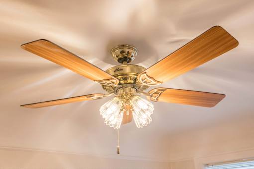 A ceiling fan with a light fixture is hanging from the ceiling.at Palladian Apartments, Oregon, 97201?