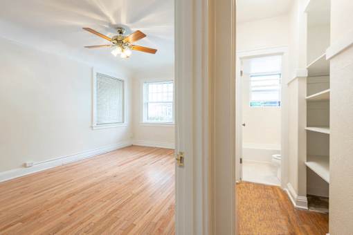 A room with a ceiling fan and wooden floors.at Palladian Apartments, Portland, 97201 ? 