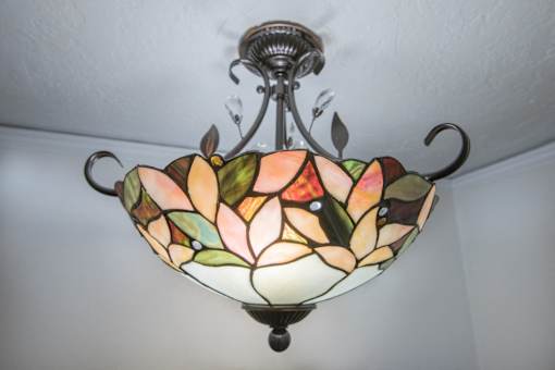 A stained glass chandelier with a floral design hangs from the ceiling.at Palladian Apartments, Portland, OR 97201 ? 