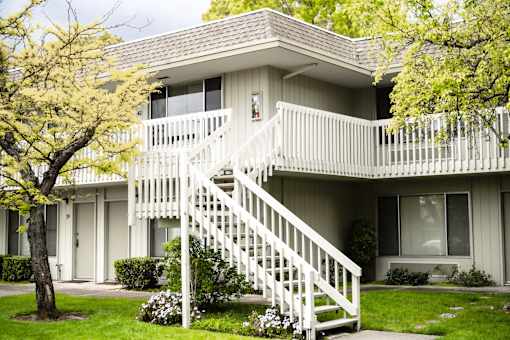 an exterior view of an apartment building with a white staircase at OTAVON APARTMENTS, Novato California